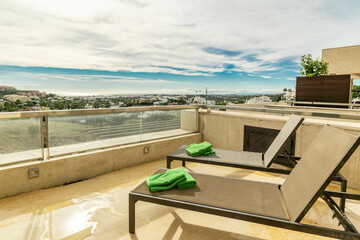 a view overlooking the Mediterranean coastline of the Costa Del Sol From the terrace of a luxury apartment complete with loungers close up 