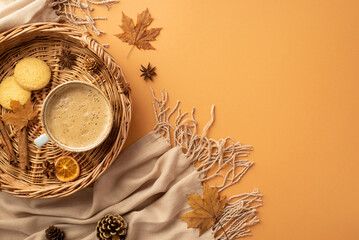 Autumn concept. Top view photo of wicker tray with cup of coffee cinnamon sticks cookies dried orange slice anise yellow maple leaves scarf and pine cones on isolated orange background