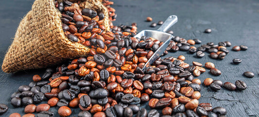 Close-up of a blended blend of dark roast and a medium roast of roasted coffee beans in a brown...