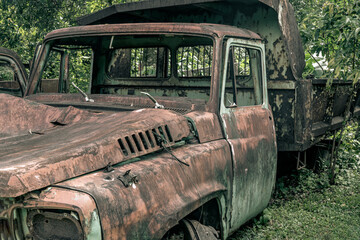 Old vintage truck car wreck used to transport ore from the mine to the steelworks. Old abandoned mining truck in old mining town area, Selective focus.