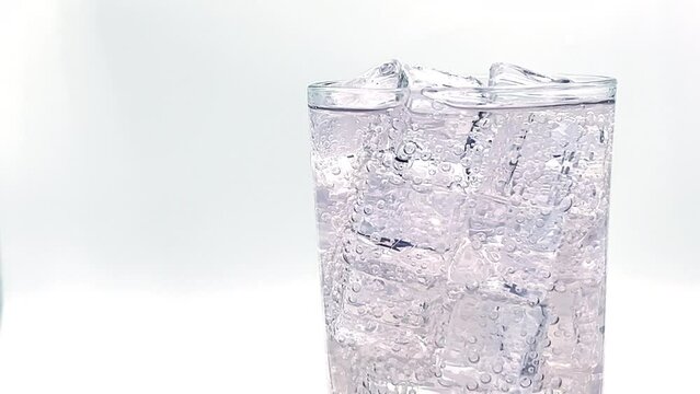 close up of soda water  and  ice with bubbles. Sparkling cold soft drink, carbonated with cool iced tonic in a glasses.