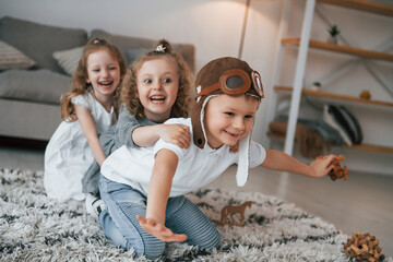 Playful mood. Tetro aviator glasses. Group of children is together at home at daytime