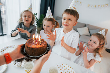 Birthday cake. Group of children is together at home at daytime