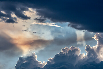 Thunder clouds merging prior to dramatic lightning storm at sunset
