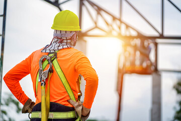 Construction workers wear safety belts.