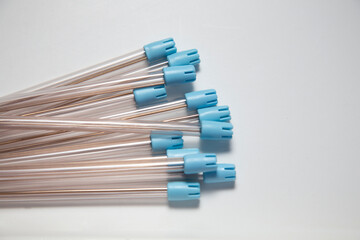 Group of transparent ejectors with light blue on white background with space for text. Dentistry concept