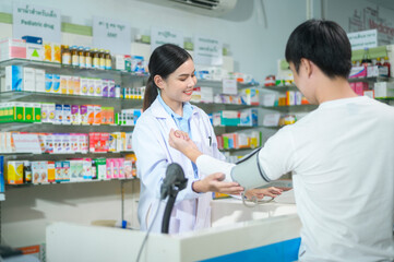 Female pharmacist counseling customer about drugs usage in a modern pharmacy drugstore.