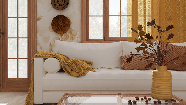 Vintage living room in white and yellow tones closeup. Sofa, rattan table with autumn decors. vase with dry leaves and acorns. Boho chic design, fall interior concept
