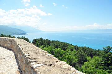 Fototapeta na wymiar View from Samuel's Fortress overlooking lake Ohrid in Macedonia on a sunny summer day. Ruin walls partly visible in horizontal image.