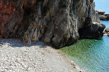 Cliff side rocks with vegetation near Adriatic ocean in Montenegro. Tagging on the mountain.