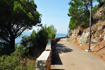 Empty walking path near Petrovac, Montenegro.  View toward the Adriatic Sea. Horizontal photo.