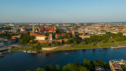Fototapeta na wymiar Poland. Krakow skyline with Wawel Hill, Cathedral, Royal Wawel Castle, defensive walls,Vistula riverbank, park, promenade, walking people. Old city in the background