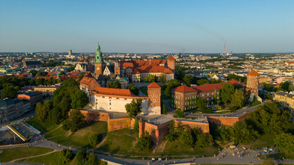 Fototapeta premium Poland. Krakow skyline with Wawel Hill, Cathedral, Royal Wawel Castle, defensive walls,Vistula riverbank, park, promenade, walking people. Old city in the background
