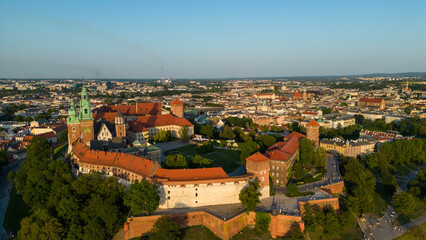 Fototapeta premium Poland. Krakow skyline with Wawel Hill, Cathedral, Royal Wawel Castle, defensive walls,Vistula riverbank, park, promenade, walking people. Old city in the background