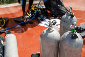 Close-up of scuba diving tanks on a tropical beach in Mexico. In the background the Caribbean Sea....