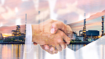 Double exposure of business handshake and oil refinery plant. Business people shaking hands in the...