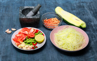Healthy food ingredient papaya salad or som tum thai on wood background.