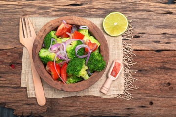 Healthy food vegetable broccoli salad in bowl on wood background.