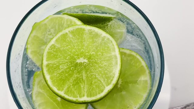 Extreme close up slow motion of sparkling lime soda juice drink.  