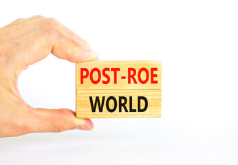 Naklejka na ściany i meble Roe vs Wade post-Roe world symbol. Concept words Post-Roe world on wooden blocks on a beautiful white background. Businessman hand. Business and Roe vs Wade post-Roe world concept. Copy space.