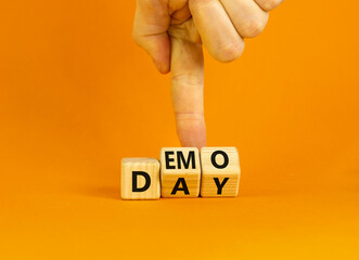 Demo day symbol. Concept words Demo day on wooden cubes. Businessman hand. Beautiful orange table orange background. Business and demo day concept. Copy space.