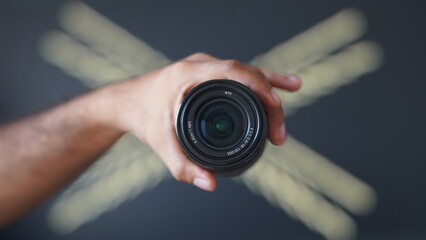 holding lens in hand HD image.