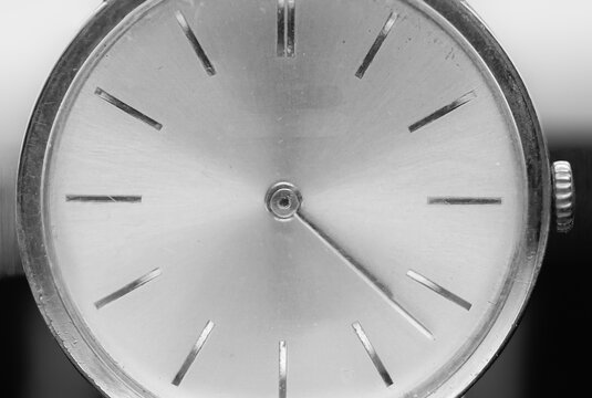 Macro photo of a men's watch. Clock hands. An antique clock. Black and white photo. Time signals. Wristwatch.