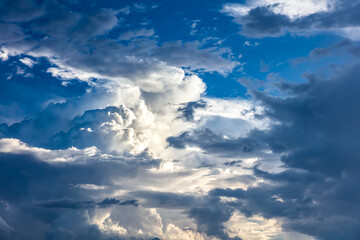 Fototapeta premium Closeup of Billowy cumulus clouds. Wispy clouds, deep blue sky in background. 