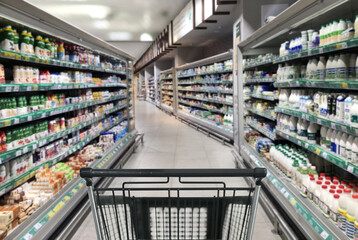 choosing a dairy products at supermarket.empty grocery cart in an empty supermarket
