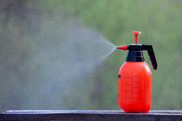An insect sprayer sprays poison from pests. - obrazy, fototapety, plakaty