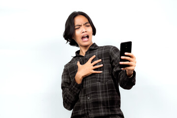 Fototapeta premium Surprised young Asian man looking at his smartphone. Surprised to see the news. Surprised Expression.