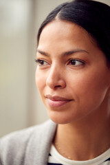 Head And Shoulders Portrait Of Woman Or Businesswoman Standing By Window In Office Or At Home