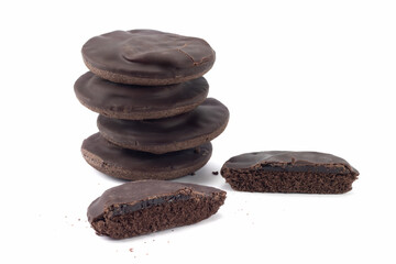 Chocolate cookies with jelly isolated on bright background. Crumbs of cake. Close up view.