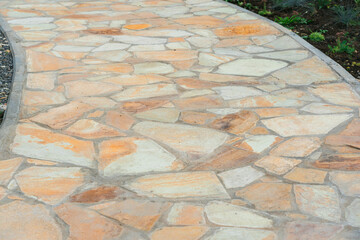 Garden path made of yellow sandstone stones