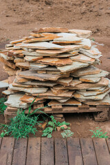 Yellow sandstone stones on wooden pallets