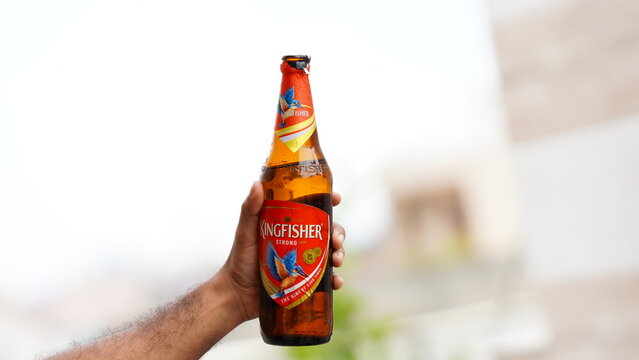 Sitamarhi, Bihar, India- 14 ‎June ‎2022 :showing up a beer bottle holding in hand .