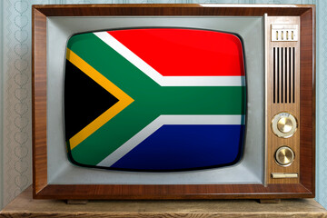 old tube vintage TV with the national flag of South Africa on screen, stylish interior of 60s, the...