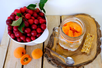 fresh juice fruit and berry low-calorie mousse, dessert in glass with bubble tea, ripe apricots, cherry plums, pears, muesli bar, concept of healthy eating, vegan diet, raw food, healthy food