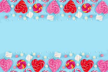 sweets, candies, cookies and lollipops on a blue background. Sweet hearts Christmas canes. Top view copy space