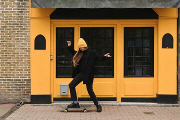 Girl in a yellow hat with a skateboard
