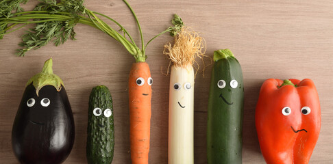 Raw of funny vegetables with eyes and mouths child nutrition