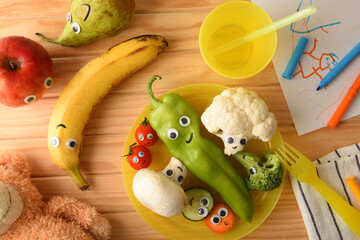Concept of fun fruit and vegetables served for a child