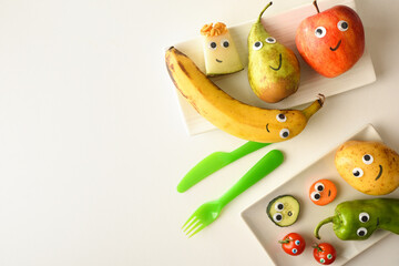 Background with funny fruit plate served for children on table