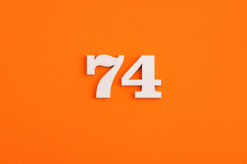 Number 74 - On orange foam rubber background