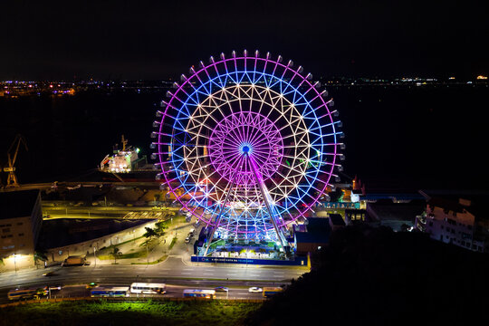 Rio de Janeiro, Brazil - August 3, 2022: Yup Star (Rio Star) ferris wheel at night is illuminated with colorful RGB led lights.