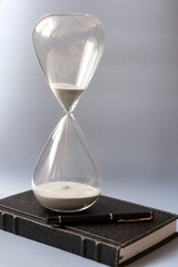 hourglass and notepad as business concept