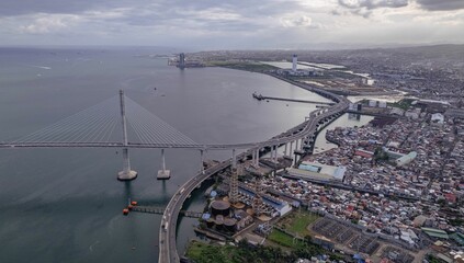 Aerial view of seaside Cebu cityscape and Cebu-Cordova bridge in the Philippines