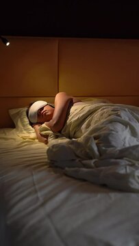 Young woman sleeping in bed