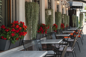 Cozy tables in a street cafe. Life in the city.