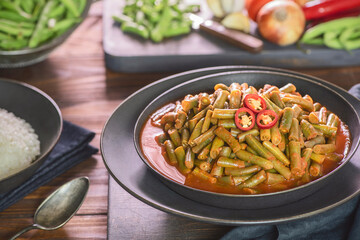 Arabic Cuisine; Egyptian traditional green bean stew. A delicious vegan meal with fresh green beans doused in aromatic tomato sauce. Served with white rice.